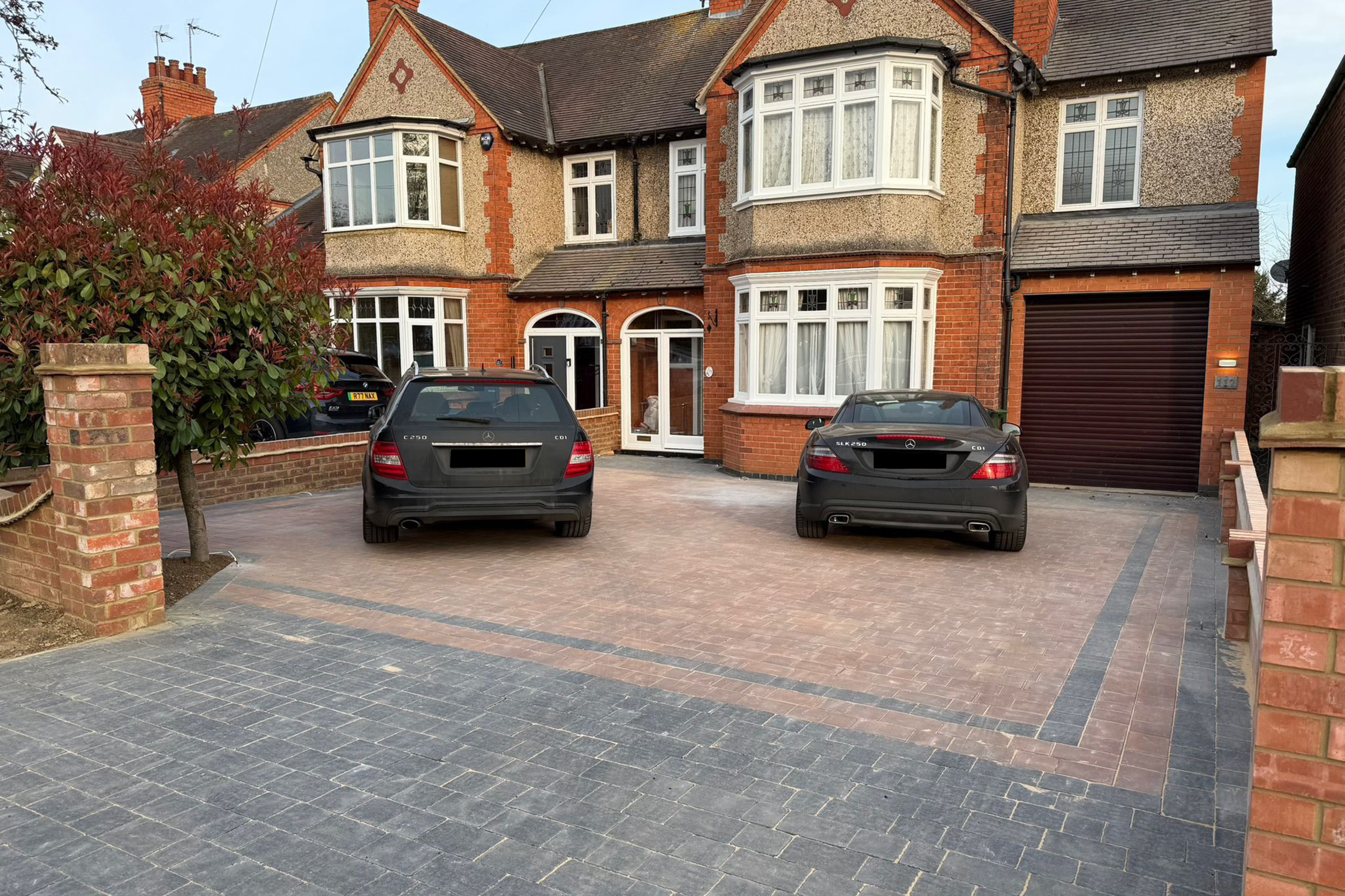Block paving driveway with vehicle parked